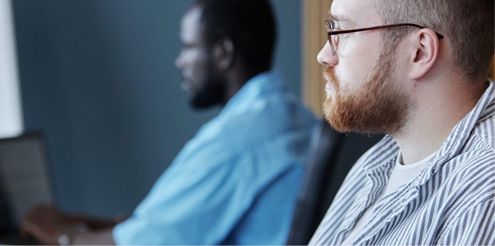 Students working intently on computers in a technical training session